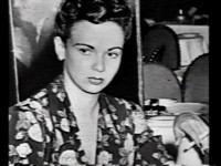 She's smoking a cigarette and not smiling.
